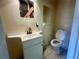 Bathroom featuring a toilet, sink with a vanity, and exposed framing at 1905 Yale Ave, Bradenton, FL 34207