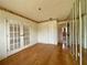 Bedroom with hardwood floors, closet, and mirrored wall at 1905 Yale Ave, Bradenton, FL 34207