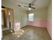 Bedroom features closet space, terrazzo flooring, and a window providing natural light at 1905 Yale Ave, Bradenton, FL 34207