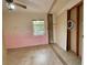 Bedroom with original terrazzo flooring and natural light coming through the window at 1905 Yale Ave, Bradenton, FL 34207