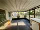 Enclosed porch with screens and a view of the backyard and storage shed at 1905 Yale Ave, Bradenton, FL 34207
