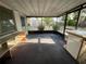 Enclosed porch with screens and a view of the backyard and storage shed at 1905 Yale Ave, Bradenton, FL 34207