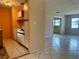 Open living area with tile flooring, and a partial view of the kitchen at 1905 Yale Ave, Bradenton, FL 34207
