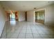 Open-concept living room with tile flooring, and sliding glass doors at 1905 Yale Ave, Bradenton, FL 34207