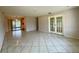 Spacious living room with tile flooring, leading to patio and kitchen at 1905 Yale Ave, Bradenton, FL 34207