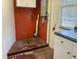 Utility room with exposed plumbing, peeling paint, and a small cabinet at 1905 Yale Ave, Bradenton, FL 34207