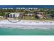 Stunning aerial view of beachfront condos with ocean views and a sparkling pool at 2045 Gulf Of Mexico Dr # M1-302, Longboat Key, FL 34228