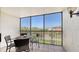 A screened balcony with furniture overlooks the neighborhood at 2045 Gulf Of Mexico Dr # M1-302, Longboat Key, FL 34228