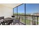 Screened in balcony with furniture overlooks the community landscaping at 2045 Gulf Of Mexico Dr # M1-302, Longboat Key, FL 34228