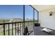 Enjoy the neighborhood view from this screened balcony with seating at 2045 Gulf Of Mexico Dr # M1-302, Longboat Key, FL 34228