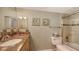Bathroom with granite counters, seashell art and shower/tub combo at 2045 Gulf Of Mexico Dr # M1-302, Longboat Key, FL 34228