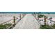 Sandy beach access path with roped railing leading to the beach and ocean at 2045 Gulf Of Mexico Dr # M1-302, Longboat Key, FL 34228