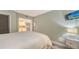 Bright bedroom with a view of the kitchen and a mounted flatscreen at 2045 Gulf Of Mexico Dr # M1-302, Longboat Key, FL 34228