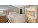 Inviting bedroom with wood floors offers entry to the adjacent kitchen at 2045 Gulf Of Mexico Dr # M1-302, Longboat Key, FL 34228