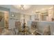 Bright dining area boasts a glass table, seating for four, and elegant decor at 2045 Gulf Of Mexico Dr # M1-302, Longboat Key, FL 34228