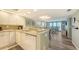 Modern kitchen flowing to living room with updated appliances and granite countertops at 2045 Gulf Of Mexico Dr # M1-302, Longboat Key, FL 34228