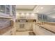 Updated kitchen features granite counters, white cabinetry, and modern appliances at 2045 Gulf Of Mexico Dr # M1-302, Longboat Key, FL 34228