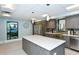 Kitchen with modern appliances, center island and pendant lighting at 2045 Gulf Of Mexico Dr # M1-302, Longboat Key, FL 34228