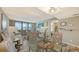 Bright open floor plan with a dining area, living room, and sliding door balcony access at 2045 Gulf Of Mexico Dr # M1-302, Longboat Key, FL 34228