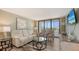 Comfortable living room with ample seating and access to a screened lanai at 2045 Gulf Of Mexico Dr # M1-302, Longboat Key, FL 34228