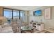 Bright living area featuring a sliding glass door to balcony and comfortable seating at 2045 Gulf Of Mexico Dr # M1-302, Longboat Key, FL 34228