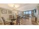 Spacious living area with dining space, balcony access, and comfortable seating arrangements at 2045 Gulf Of Mexico Dr # M1-302, Longboat Key, FL 34228