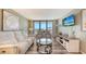 Inviting living room with stylish furniture and sliding glass doors to the balcony at 2045 Gulf Of Mexico Dr # M1-302, Longboat Key, FL 34228