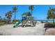 Beach playground with a slide and swings is perfect for children at 2045 Gulf Of Mexico Dr # M1-302, Longboat Key, FL 34228