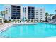Relaxing pool area with lounge chairs and umbrellas, perfect for a resort-style living at 2045 Gulf Of Mexico Dr # M1-302, Longboat Key, FL 34228