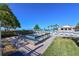 Community pool with lounge chairs and jacuzzi overlooking the beach at 2045 Gulf Of Mexico Dr # M1-302, Longboat Key, FL 34228