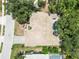 An aerial view shows the home's roof, a swimming pool, mature trees and a well-manicured lawn at 2067 Tocobaga Ln, Nokomis, FL 34275