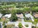 An aerial view of a single-story home surrounded by a golf course and mature trees at 2067 Tocobaga Ln, Nokomis, FL 34275