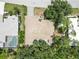 This aerial shot shows the home's proximity to another residence and the mature trees on the property at 2067 Tocobaga Ln, Nokomis, FL 34275