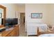 Bright bedroom featuring a crib, wicker bed, and a view to the hall at 2067 Tocobaga Ln, Nokomis, FL 34275