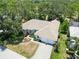 This aerial view shows the home's well-maintained landscaping, tile roof and attached two-car garage at 2067 Tocobaga Ln, Nokomis, FL 34275