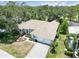 Aerial view of a well-maintained home with a three-car garage, lush landscaping and a paved driveway at 2067 Tocobaga Ln, Nokomis, FL 34275