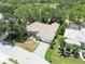 Aerial view of a well-maintained home with a three-car garage, lush landscaping and a paved driveway at 2067 Tocobaga Ln, Nokomis, FL 34275