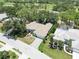 This aerial view highlights the home's tile roof, mature landscaping, and proximity to neighboring residences at 2067 Tocobaga Ln, Nokomis, FL 34275