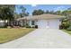 Beautiful home with a beige exterior, well-manicured lawn, and an attached two-car garage at 2067 Tocobaga Ln, Nokomis, FL 34275