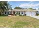 Inviting single-story home featuring a well-manicured lawn, beige exterior, and two-car garage at 2067 Tocobaga Ln, Nokomis, FL 34275