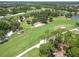 This aerial photo showcases a scenic golf course with well-manicured green and sandy bunkers at 2067 Tocobaga Ln, Nokomis, FL 34275