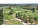 The aerial shows a beautifully landscaped golf course surrounded by trees and water features at 2067 Tocobaga Ln, Nokomis, FL 34275