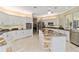 Bright and spacious kitchen featuring an island with barstool seating, stainless appliances, and granite counters at 2067 Tocobaga Ln, Nokomis, FL 34275