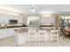 Spacious kitchen featuring an island with barstool seating, granite countertops, and white cabinetry at 2067 Tocobaga Ln, Nokomis, FL 34275