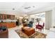 Spacious living room with a wet bar, tiled flooring, and sliding glass doors at 2067 Tocobaga Ln, Nokomis, FL 34275