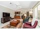 Inviting living room featuring tile floors, a wet bar, and an array of seating options at 2067 Tocobaga Ln, Nokomis, FL 34275
