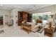 Spacious living room featuring tile flooring, comfortable seating, and sliding glass doors to the outdoor area at 2067 Tocobaga Ln, Nokomis, FL 34275