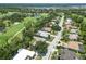 The aerial shows a neighborhood bordering a golf course, with tree-lined streets and well-maintained properties at 2067 Tocobaga Ln, Nokomis, FL 34275