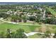 This aerial shows a neighborhood bordering a golf course, with lush greenery and well-spaced homes at 2067 Tocobaga Ln, Nokomis, FL 34275