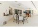 Bright, covered patio features a ceiling fan, bar and dining area with views of the outdoor space at 2067 Tocobaga Ln, Nokomis, FL 34275
